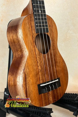 Wooden ukulele with brown finish and black fretboard, part of the Exquisite KoAloha KSM-00