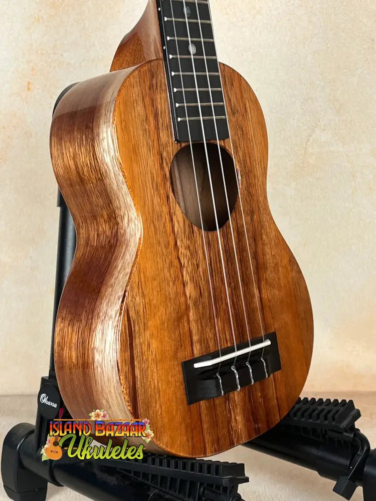 Wooden ukulele with brown finish and black fretboard, part of the Exquisite KoAloha KSM-00