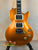 Metallic orange Les Paul-style electric guitar showcasing the Flight Centurion GT Tenor design