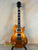 Gold metallic Les Paul-style electric guitar with dual humbuckers for Centurion GT Tenor