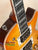 Electric guitar with sunburst orange finish and chrome hardware for Centurion VB Tenor