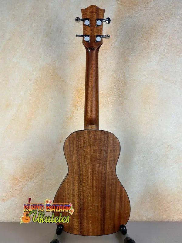 Wooden ukulele with natural finish and black tuning pegs, Flight Juliana Acacia Concert