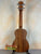 Wooden ukulele with natural finish and black tuning pegs, Flight Juliana Acacia Concert