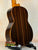 Classical acoustic guitar featuring dark striped wood back and sides with Ohana TK-50G