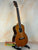 Wooden Ohana TK-50G Solid Cedar & Rosewood Tenor Ukulele on a black stand