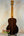 Acoustic guitar with dark striped wood grain, showcasing Ohana TK-50G Rosewood Tenor Ukulele