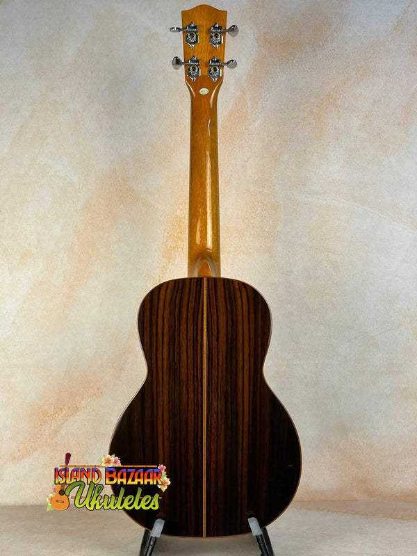 Acoustic guitar with dark striped wood grain, showcasing Ohana TK-50G Rosewood Tenor Ukulele