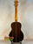 Acoustic guitar with dark striped wood grain, showcasing Ohana TK-50G Rosewood Tenor Ukulele