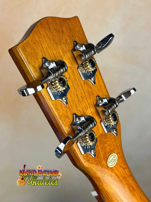 Guitar headstock with chrome tuning pegs on honey wood of Ohana TK-50G Solid Cedar Ukulele