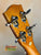 Guitar headstock with chrome tuning pegs on honey wood of Ohana TK-50G Solid Cedar Ukulele