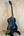 Teal Kala Archtop Tenor Ukulele KA-JTE-BKGN on a black stand, classic archtop design