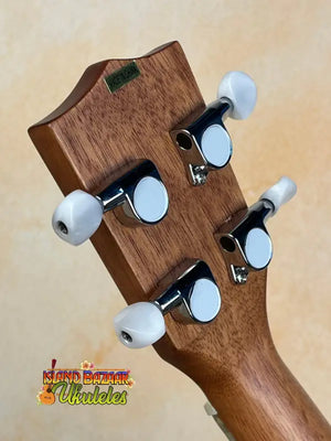 Wooden headstock of Kala Archtop Tenor Ukulele with white tuning pegs, classic archtop design