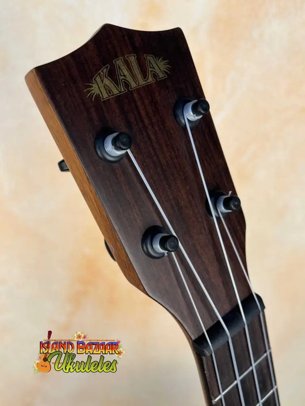 Kala Bocote Tenor Ukulele headstock featuring black tuning pegs and strings