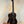 Dark wooden Kala Bocote Tenor Ukulele with striped grain on a stand, Premier Exotic Bocote