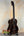 Dark wooden Kala Bocote Tenor Ukulele with striped grain on a stand, Premier Exotic Bocote
