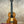 Brown wooden Kala Contour Series Tenor Ukulele with light stripe and black tuning pegs