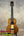 Brown wooden Kala Contour Series Tenor Ukulele with light stripe and black tuning pegs