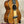 Glossy brown Kala Contour Series Tenor Ukulele with solid acacia body and white strings