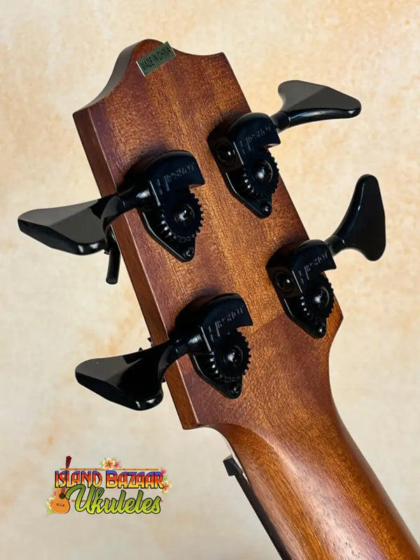 Bass guitar headstock with black tuning pegs on Kala EM-FS Exotic Macawood Tenor Ukulele