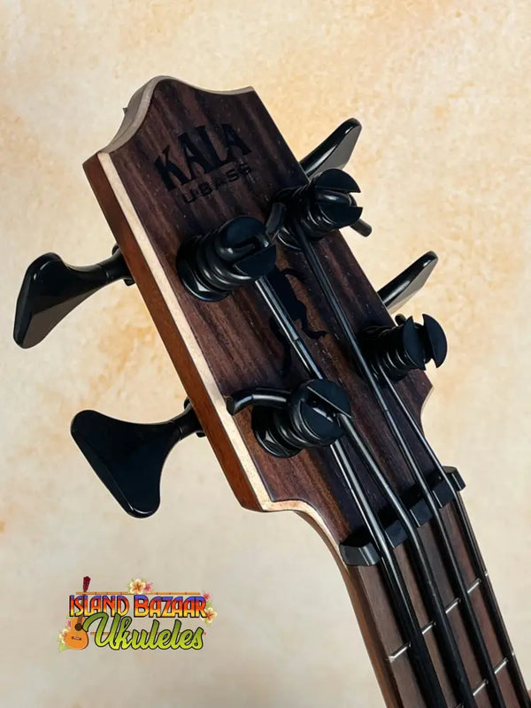 Bass guitar headstock with black tuning pegs on Kala EM-FS Exotic Macawood Tenor Ukulele