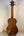 Wooden acoustic guitar with rich brown finish showcasing Kala EM-FS Exotic Macawood Tenor