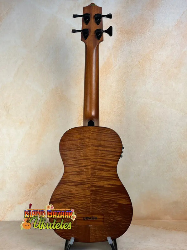 Wooden acoustic guitar with rich brown finish showcasing Kala EM-FS Exotic Macawood Tenor