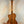 Wooden acoustic guitar back and neck showcasing Kala Gloss Spruce Cutaway Tenor Ukulele