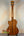 Wooden acoustic guitar back and neck showcasing Kala Gloss Spruce Cutaway Tenor Ukulele