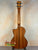 Wooden acoustic guitar back and neck showcasing Kala Gloss Spruce Cutaway Tenor Ukulele