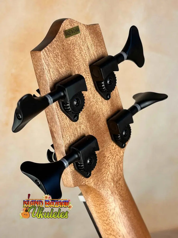 Bass guitar headstock with black tuning pegs on Kala Journeyman U•BASS® wooden neck