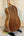 Wooden acoustic guitar with light binding on display for Kala Journeyman U•BASS®