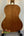 Wooden acoustic guitar back panel of Kala KA-8 Eight-String Tenor Ukulele on display stand
