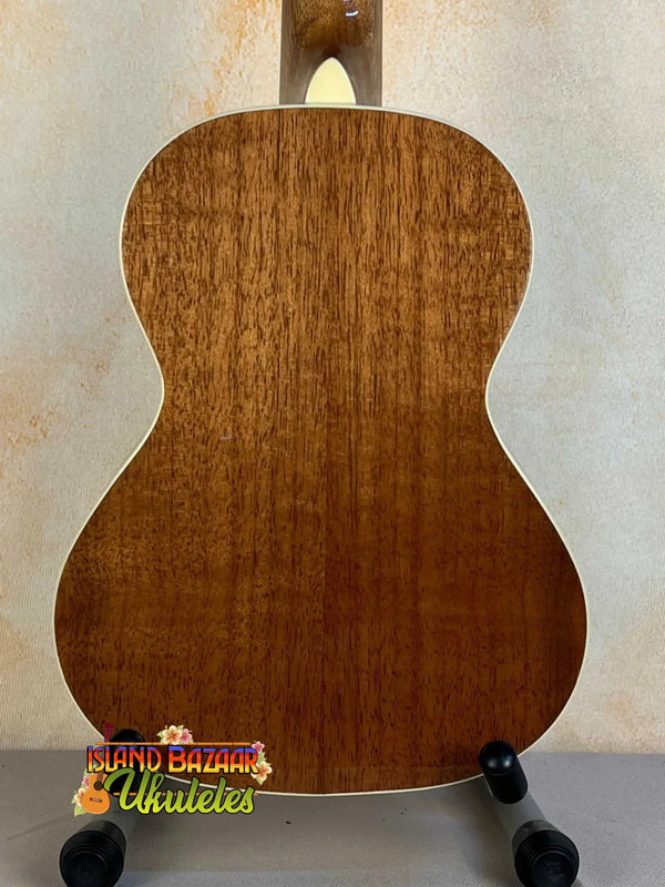 Wooden acoustic guitar back panel of Kala KA-8 Eight-String Tenor Ukulele on display stand