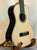 Natural wood Kala KA-ASZCT-ST Super Tenor Ukulele with black binding on a stand