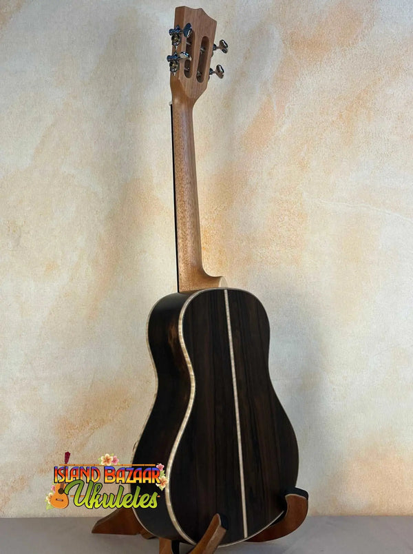 Black Kala KA-ASZCT-ST Super Tenor Ukulele with white trim on wooden stand