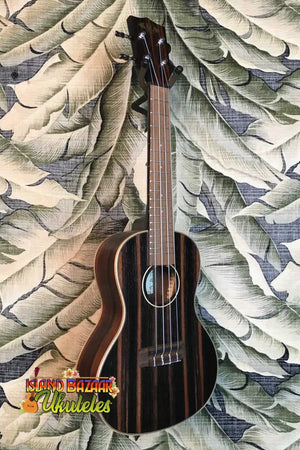 Dark wooden Kala KA-EBY-C Striped Ebony Concert Ukulele with four strings and sound hole