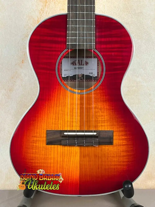 Red and orange sunburst tenor ukulele with gloss flame maple cherry burst top