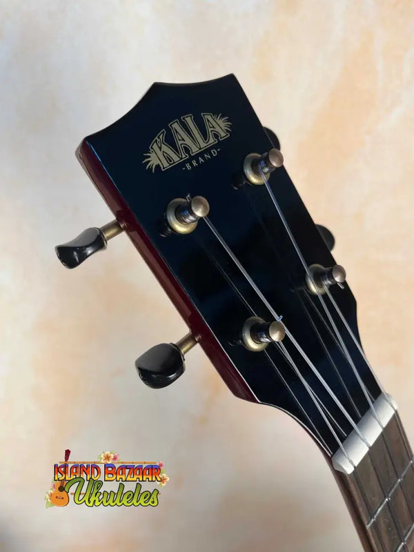 Kala KA-FMCB-T Gloss Flame Maple Cherry Burst Tenor Ukulele headstock with black tuning pegs