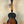 Sunburst-colored Kala KA-JTE-2TS Archtop Tenor Ukulele on a wooden stand