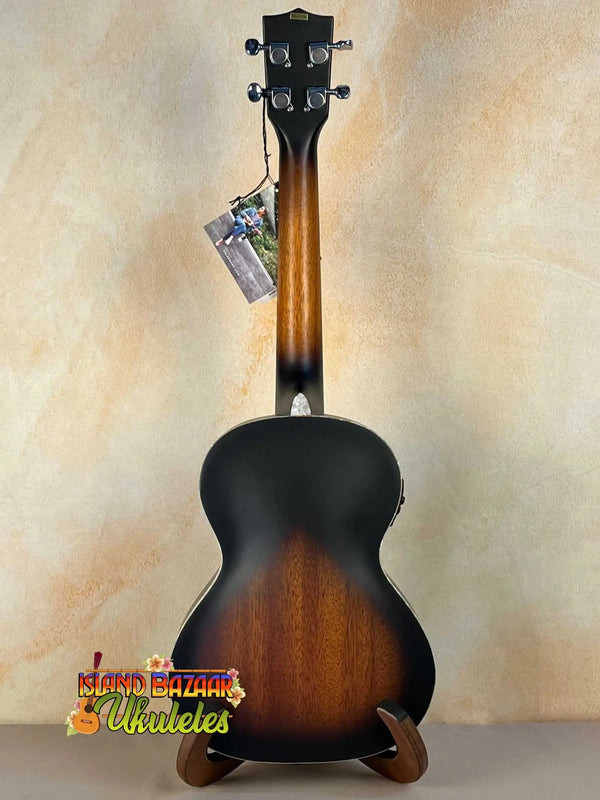 Sunburst-colored Kala KA-JTE-2TS Archtop Tenor Ukulele on a wooden stand