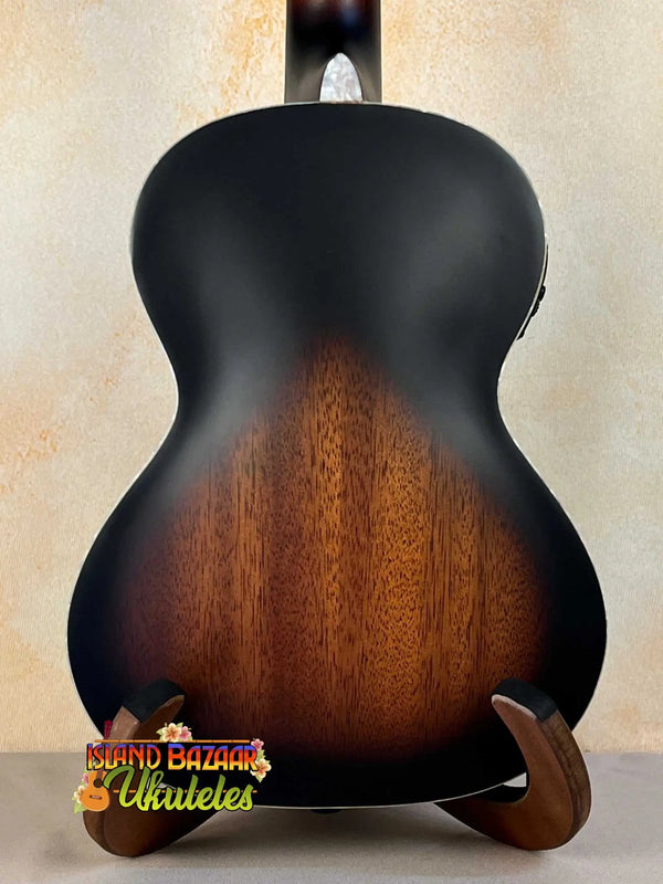 Acoustic guitar with sunburst finish on wood stand, featuring Kala KA-JTE-2TS Archtop Tenor