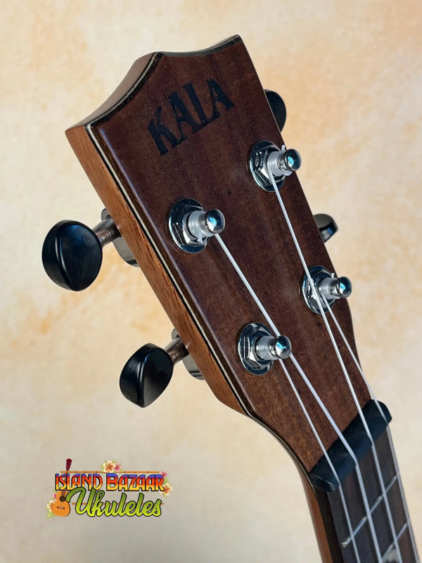 Guitar headstock with tuning pegs and Kala branding from KA-SA-C Acacia Concert Ukulele