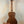 Wooden Kala KA-SA-C Acacia Concert Ukulele on a sleek black stand