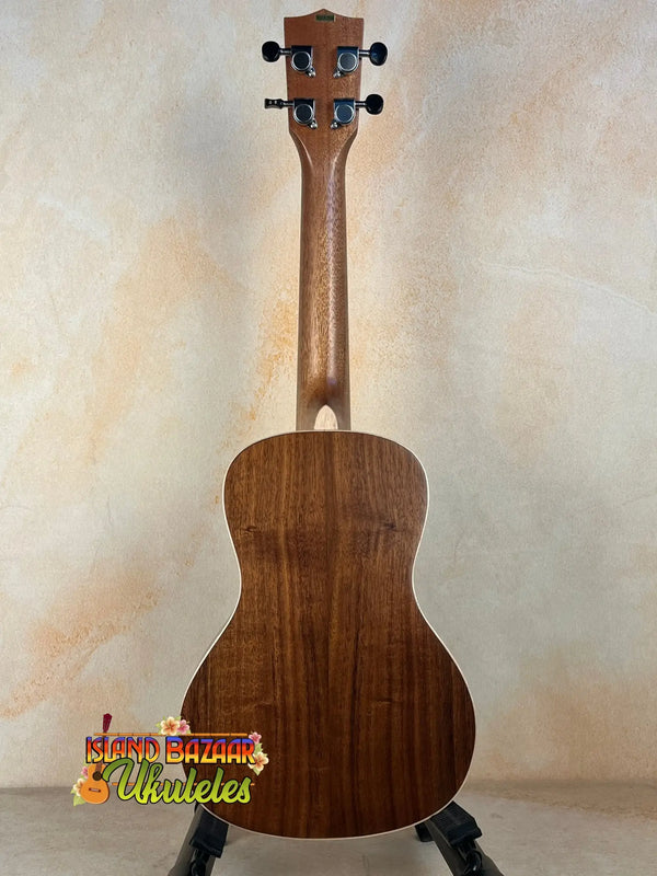 Wooden Kala KA-SA-C Acacia Concert Ukulele on a sleek black stand