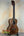 Wooden Kala KA-SA-T Acacia Tenor Ukulele with dark grain on a black stand