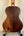 Wooden acoustic guitar on black stand featuring Kala KA-SA-T Acacia Tenor Ukulele design