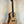 Natural wood Kala KA-SCAC-C Concert Ukulele on black stand showcasing solid cedar top