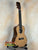 Natural wood Kala KA-SCAC-C Concert Ukulele on black stand showcasing solid cedar top