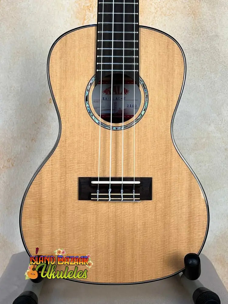 Natural wood tenor ukulele with black fretboard, part of Kala KA-SCAC-C Concert Ukulele