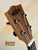 Wooden Kala KA-SCAC-T-CE Tenor Ukulele headstock with black tuning pegs and strings